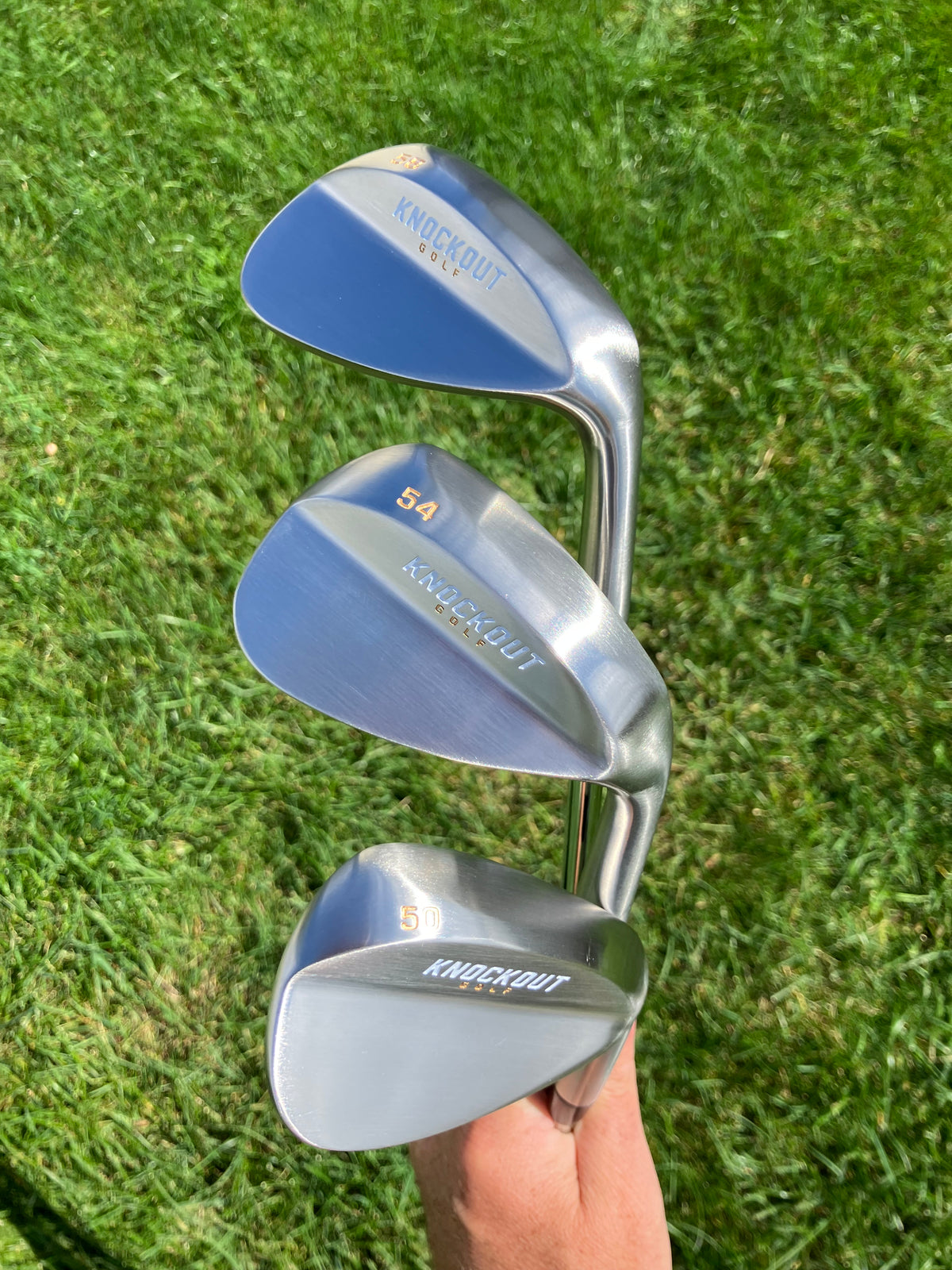 Three silver wedges in hand